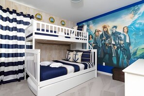 A bunk bed room with a nautical theme, including striped curtains and anchor pillows. - Solara Resort 6BR Home w/ Pool, Spa & Game Loft (Kissimmee)