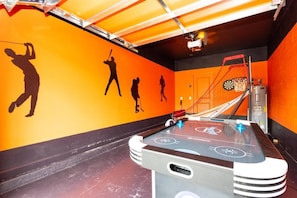 A billiards table in a room with orange walls and a ceiling with a red and white striped pattern. - 6BR Villa w/ Pool, Spa & Resort Close to Disney (Kissimmee)