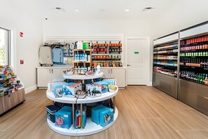 A retail store with a central display and shelves stocked with products. - Disney 6BR Villa w/ Pool & Themed Rooms (Kissimmee)