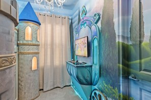 A room with a castle-like structure, a chandelier, and a wall mural. - 6BR Luxury Villa Paradiso Grande Near Disney (Orlando)