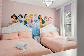 A bedroom with two beds, pink bedding, and a wall mural of animated characters. - Solterra 6BR Lakeview + Pool & Game Room (Davenport)