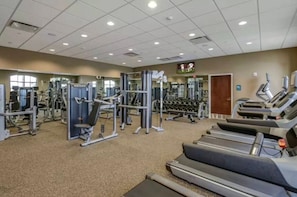 A gym with various exercise equipment, including treadmills, weight machines, and free weights. - 8BR Windsor Westside Home w/ Private Pool (Kissimmee)