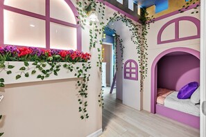 A children's playroom with a window, a bed, and a wall with a window design. - 8-bedroom Themed Villa With Private Pool (Clermont)