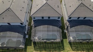 A modern building with multiple triangular roofs and large glass windows. - Luxury 8BR Villa w/ Cinema, Game Room, Pool (Orlando)