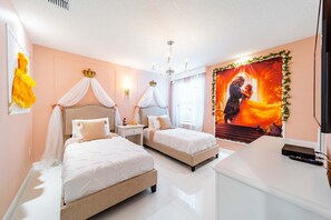 A bedroom with two beds, a chandelier, a TV, and a large poster on the wall. - Storey Lake 9BR Home w/ Pool & Epic Game Room (Kissimmee)