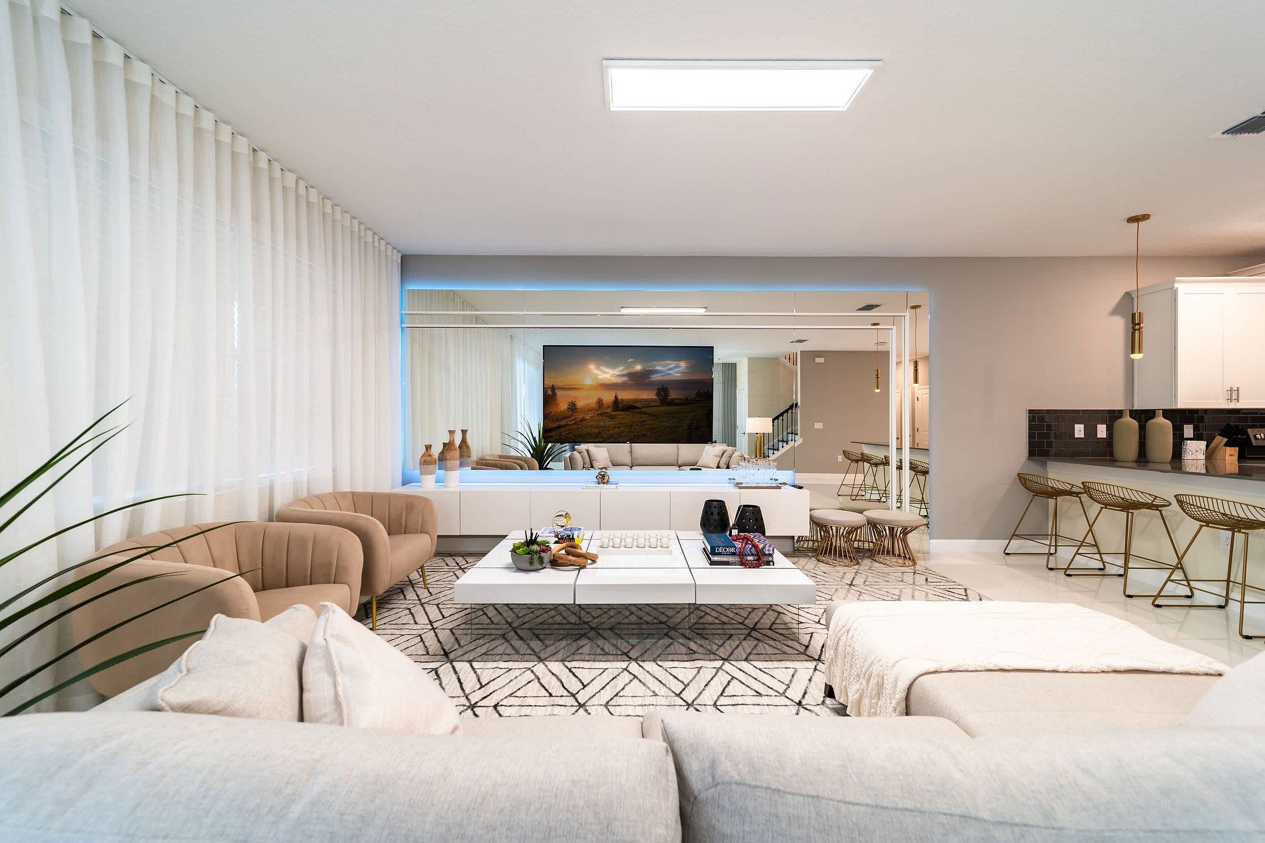 A modern living room with a sofa set, a coffee table, and a painting on the wall.