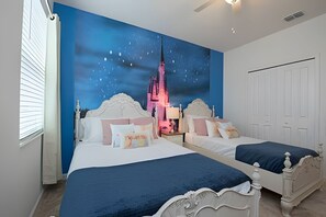 A bedroom with two beds, a mural of a city skyline, and a white door. - 9BR Disney Home w/ Pool, Spa & Theater Room (Kissimmee)