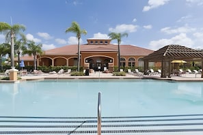A pool area with lounge chairs and a gazebo. - 9BR Disney Home w/ Pool, Spa & Theater Room (Kissimmee)