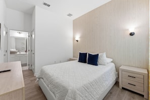 A bedroom with a bed, bedside tables, a wardrobe, and a mirror. - House 12Q With Pool With Heating - and Game Room (Kissimmee)