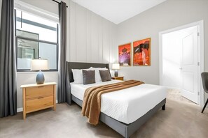 A bedroom with a bed, bedside tables, a window with curtains, and artwork on the wall. - 12br Home at Paradiso Grande, Near Disney (Orlando)