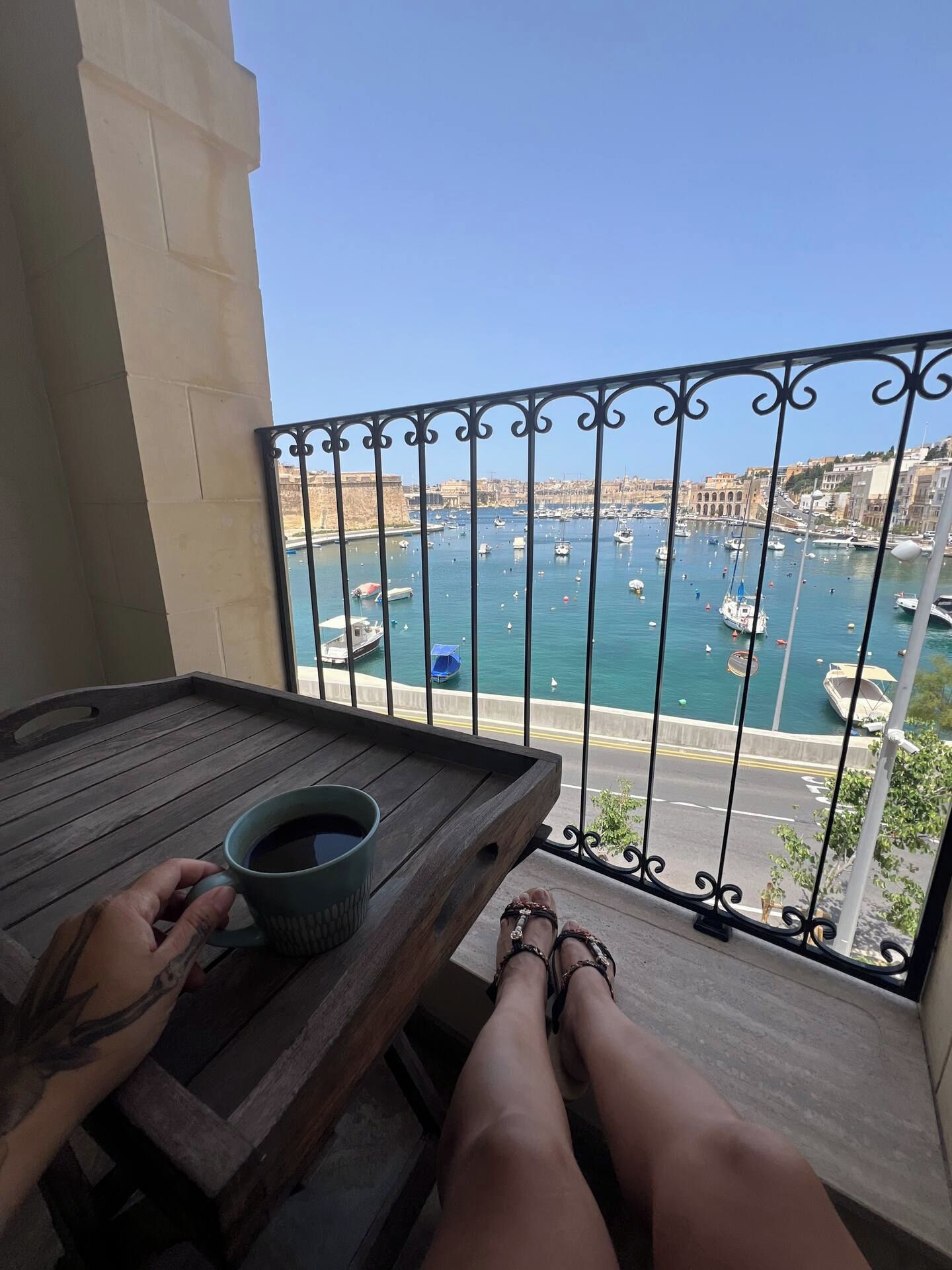 A balcony with a view of a marina and cityscape.