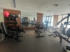 A gym with various exercise equipment, including treadmills, weight machines, and free weights. - BEAUTIFUL APARTMENT BY THE BEACH   (Cruz de Huanacaxtle)