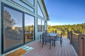 A deck with a table and chairs, overlooking a forest. - Conestoga Creek! NEW Secluded Cabin w/Deck & Views (Florissant)