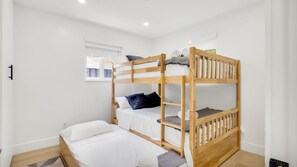 A bunk bed room with a window, a small bedside table, and a power outlet. - Entire 4 beds house w/ pool 15mint HardRockCasino, Beach, FLL Air - Cruise ports (Hollywood)