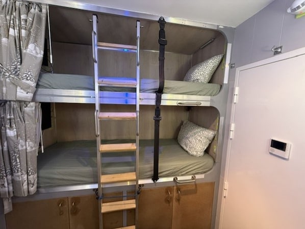 A bunk bed with a ladder, a small shelf, and a control panel on the wall. - Renovated studio, panoramic view - 4 guests (Pra-Loup)