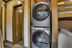 A laundry room with two stacked front-loading washing machines.
