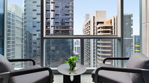 Private balcony vantage point overlooking sleek high-rise buildings and the bustling city skyline.    - Melbourne Skyline High-Rise Suite | City Views & Pool Access (Melbourne)