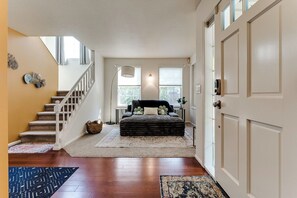A bedroom with a bed, a window, a door, and a staircase. - Stylish House w/ Backyard & Free Parking (Eugene)