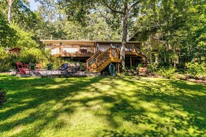 A two-story wooden house with a deck and a staircase leading to the upper level. - Scenic Eugene Home w/ Deck 1mi to UofO (Eugene)