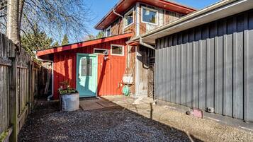 A two-story house with a red door and a garage.