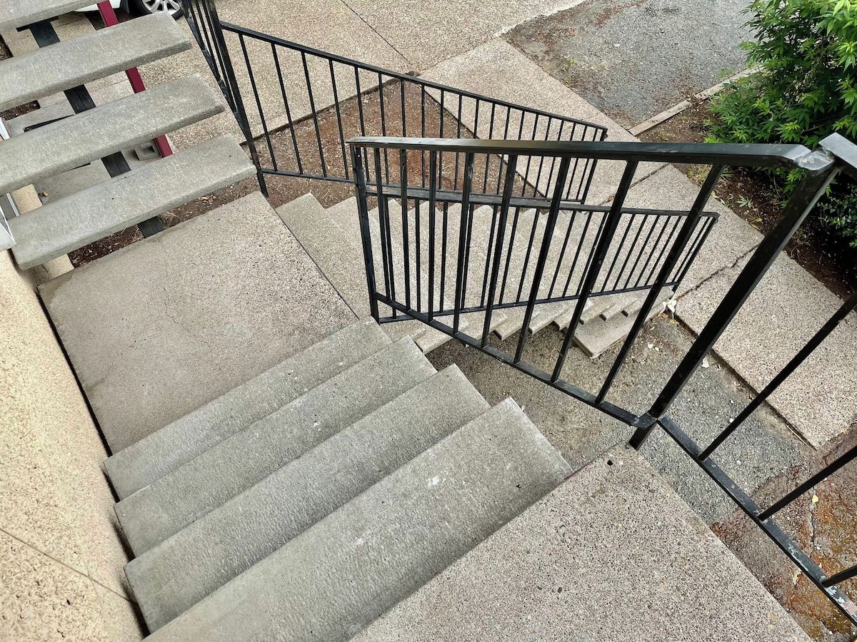 A concrete staircase with metal railings.