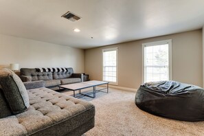 A living room with a sofa set, a coffee table, and a bean bag. - Thurston Hills Retreat: Modern Home w/ Scenic (Springfield)