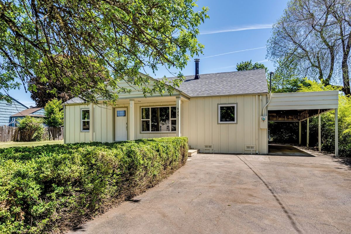 A single-story house with a covered porch, a garage, and a well-maintained front yard.
