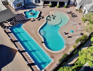 A large swimming pool with multiple sections and lounge chairs. - Hollow Sands Basecamp | Hot Tub | Pool | Fire Pit (Hurricane)