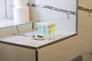 A bathroom counter with three toiletries and a mirror. - Sutherland Apartments - Apt 25 (London)