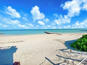 A beach with clear skies and calm waters. - Perfect beachfront 3-bedroom house with AC in tranquil Chelem (Chelem)