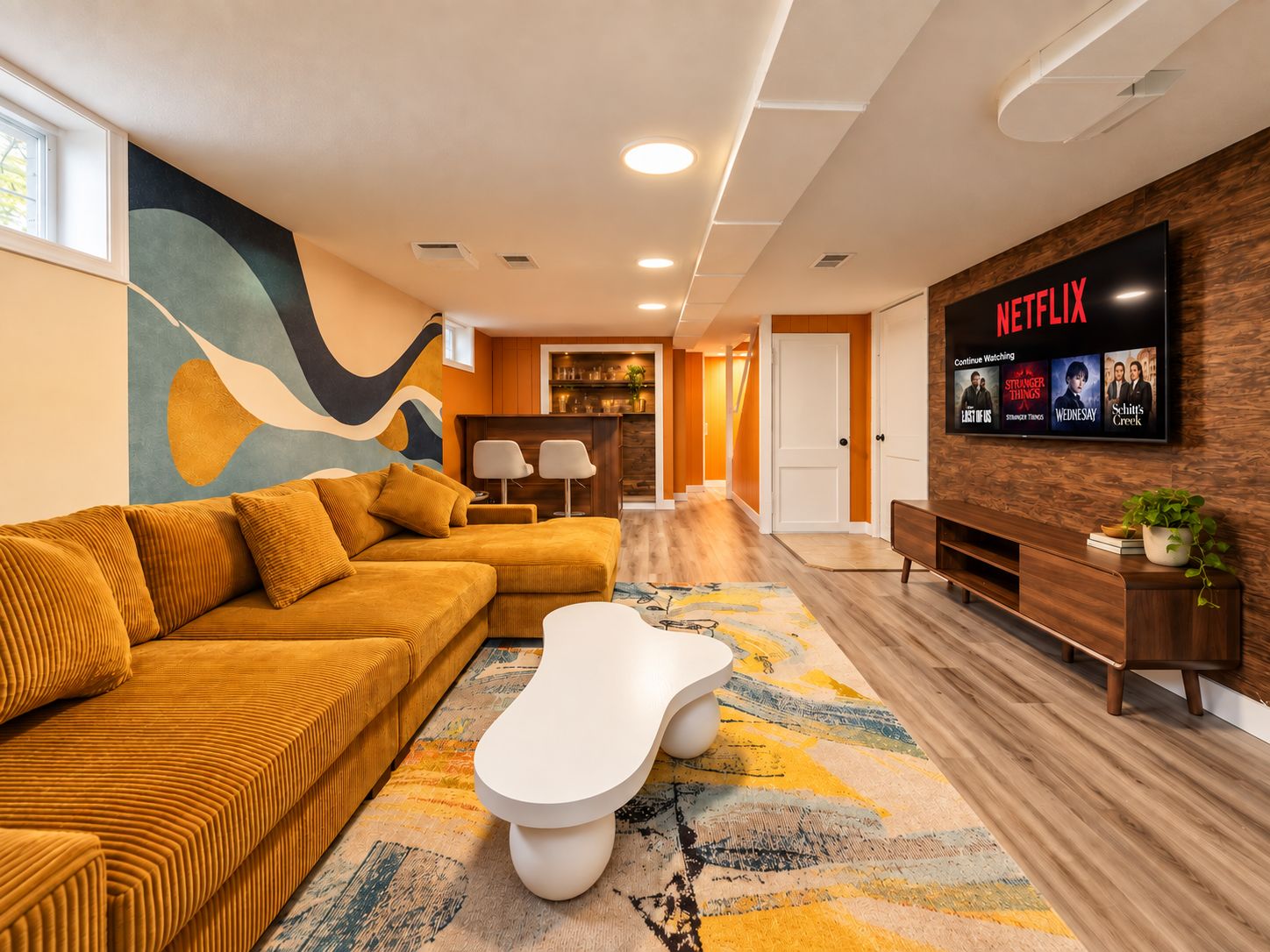 A modern living room with a sofa, coffee table, and a flat-screen TV displaying Netflix content.