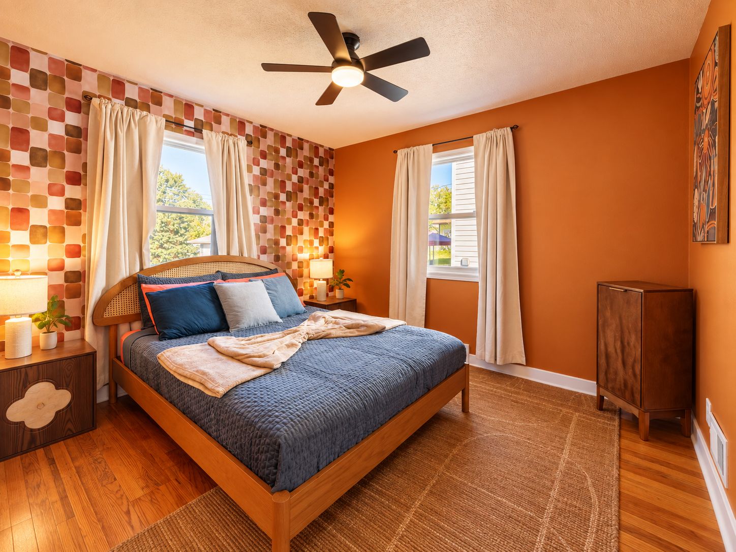 A bedroom with a wooden bed, a ceiling fan, and a window with curtains.