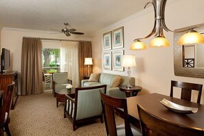 A hotel room with a dining area, a sofa, a television, and framed artwork on the wall. - Sheraton Vistana Resort, 2-Bdr. Villa, Sleeps 8, Full Kitchen, Near Disney World (Orlando)