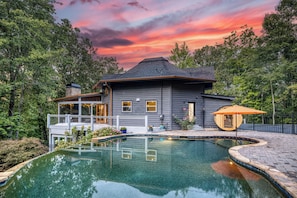 A two-story house with a swimming pool, surrounded by trees. - Private Pool, Fenced Yard, Sauna, Hot Tub & Outdoor Fireplace | 5 Min downtown (Ellijay)