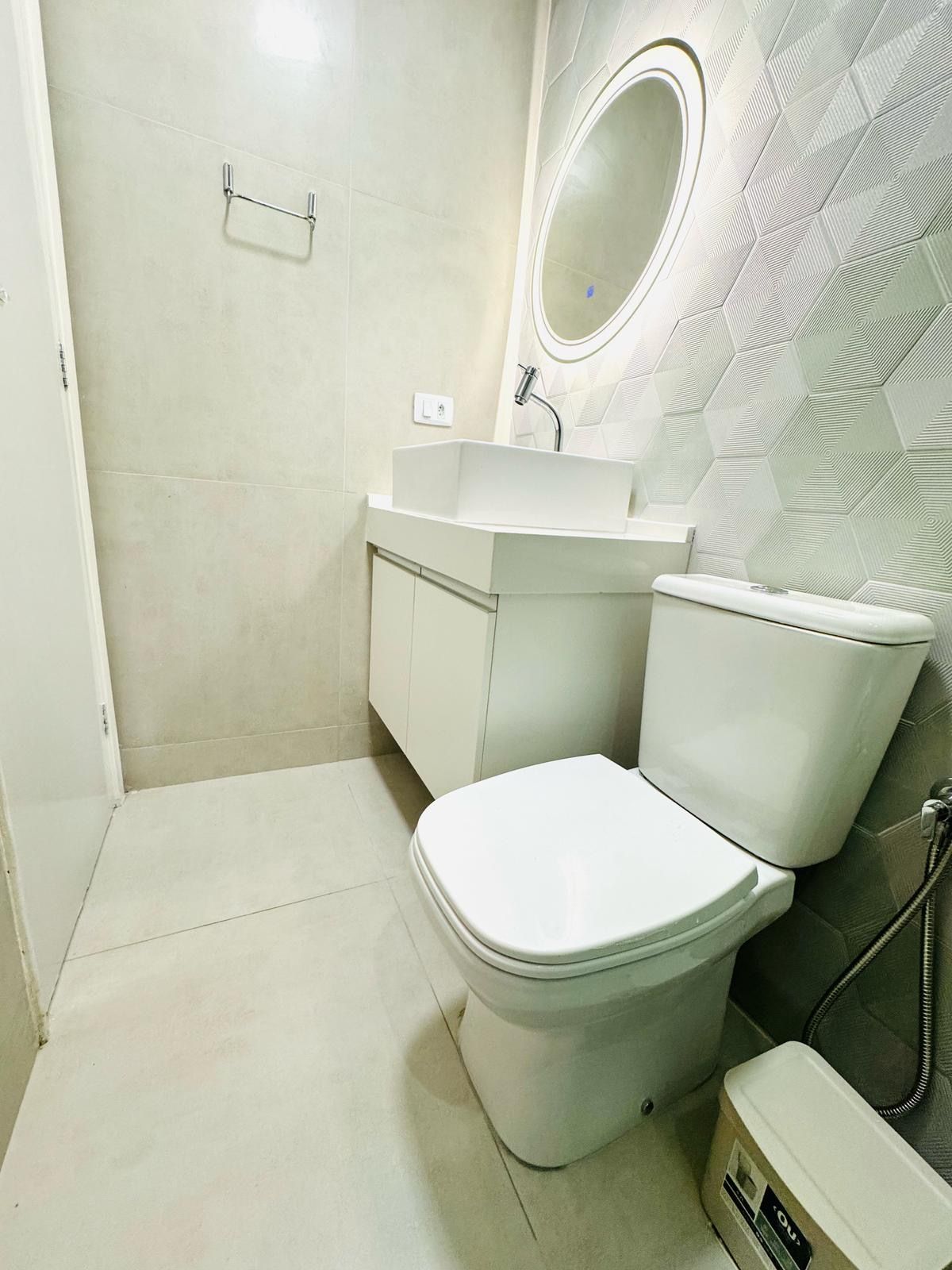 Ein Badezimmer mit Toilette, Waschbecken und Spiegel.