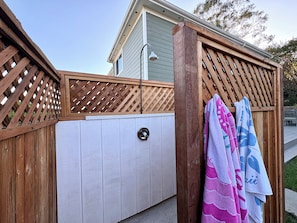 A wooden fence with a lattice design, a white exterior wall, and a metal door with a handle. - 5 minutes to the beach! The Hideaway on Lillie Ave. (Summerland)