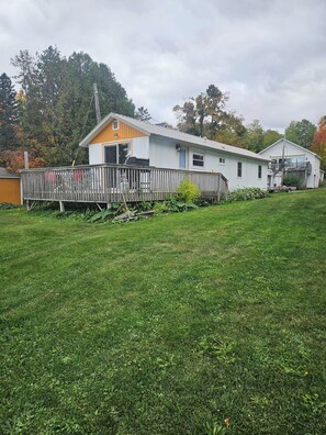 A single-story house with a fenced yard and a small deck.