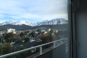 A view of a town with buildings and snow-capped mountains in the background. - Josefina: Scenery and Tranquility (Ushuaia)