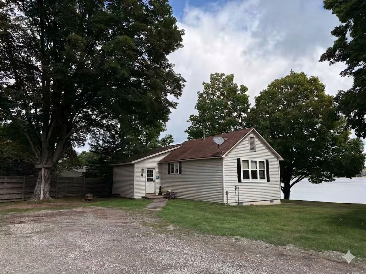 A single-story house with a sloped roof, a front door, and a garage door.