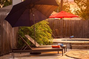 A backyard with a pool, lounge chairs, and umbrellas. - Private Pool & Loungers | Theater, Dry Sauna & Games (San Antonio)