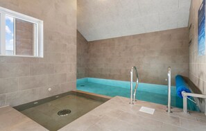 A spa area with a hot tub, a walk-in shower, and a window with blinds. - Cozy home in Hvide Sande with sauna (Hvide Sande)