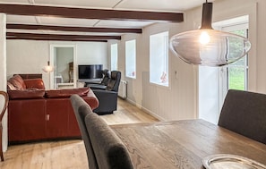 A modern living room with a sofa, chairs, a dining table, and a TV. - Gorgeous home in Skærbæk with WiFi (Skærbæk)