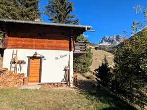 A rustic mountain lodge with a wooden exterior, a door, and a sign reading 'Le Kourme'. - Charming chalet near the funicular for 5-6 peopleOutside: detached chalet near the funicular with la (St-Luc)