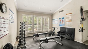 A gym with exercise equipment, a bench, and a wall with workout posters. - Roadrunner Haven — warm and welcoming Monthly Rent (Scottsdale)