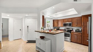A modern kitchen with white cabinetry, granite countertops, and stainless steel appliances. - Roadrunner Haven — warm and welcoming Monthly Rent (Scottsdale)