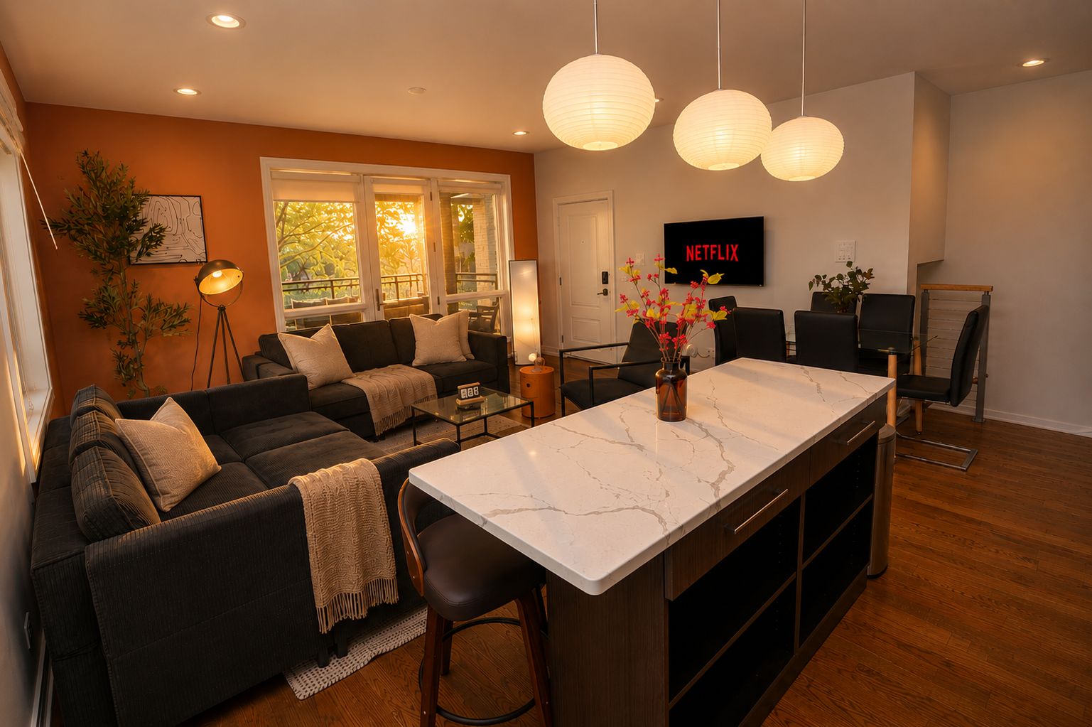 A modern living room with a sofa, coffee table, and a TV displaying 'NETFLIX'.