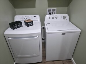 A laundry room with two white washing machines and a black box labeled 'DRYER SHEETS' on the left. - Your Home Away From Home- Private Oasis (Wichita)