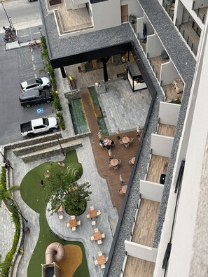 A multi-level outdoor area with a pool, seating, and a covered section. - NEW BELLA VISTA (Puerto Vallarta)