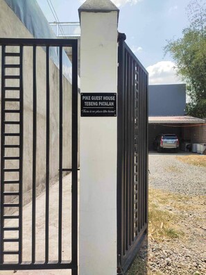 A gated entrance to Pike Guest House with a sign indicating its location in Tebeng Patalan. - Pike Guest House - Modern Western Style House (Dagupan)