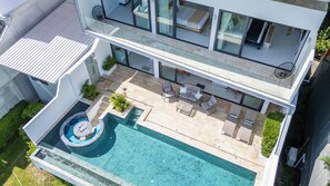 A modern two-story house with a swimming pool, outdoor seating, and a glass-enclosed balcony. - Villa Satori 3 Bed Seaview Infinity Pool (Bophut, Koh Samui)